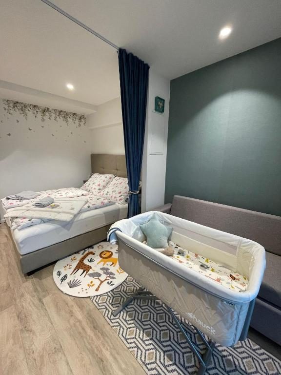 Baby crib beside a made-up bed in the apartment