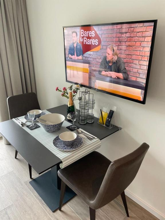 Dining corner with wall-mounted Smart TV and table set for two