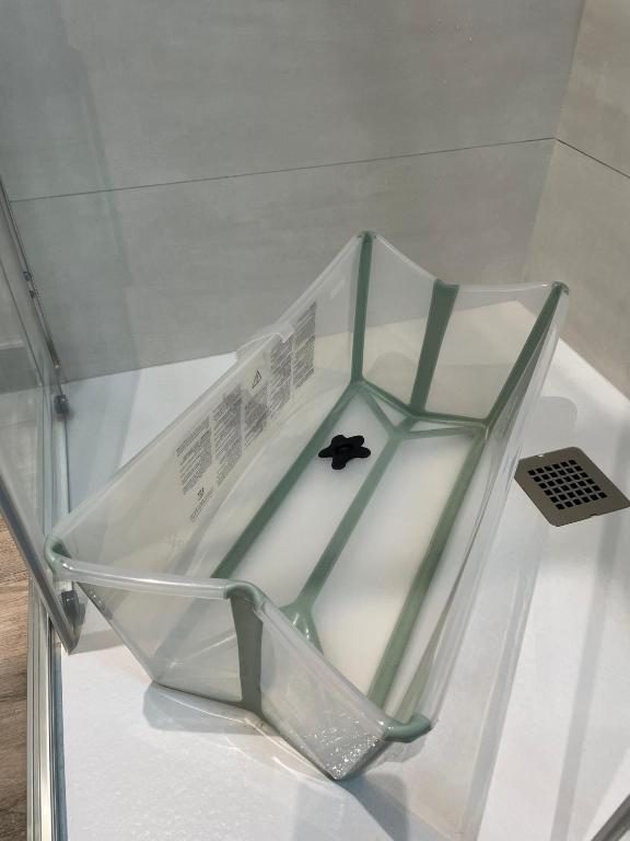 Foldable baby bathtub placed in the walk-in shower
