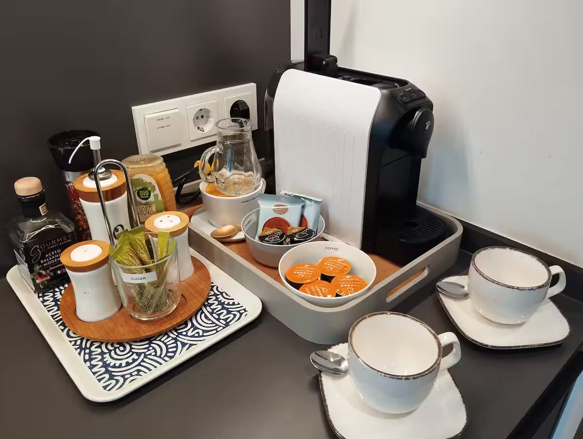 Coffee station with capsule machine, espresso cups and starter supplies