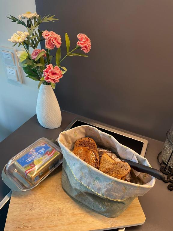 Fresh bread basket and breakfast basics on the kitchen counter