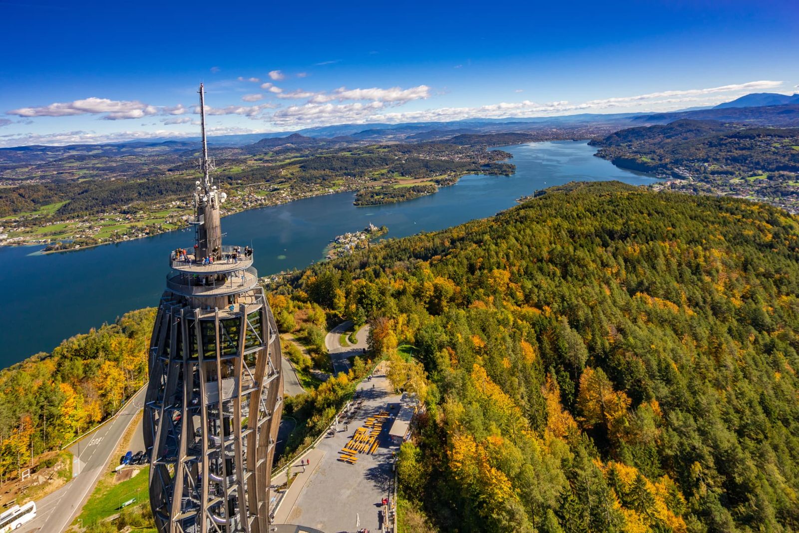 Pyramidenkogel observation tower above autumn forests with Lake Wörthersee beyond