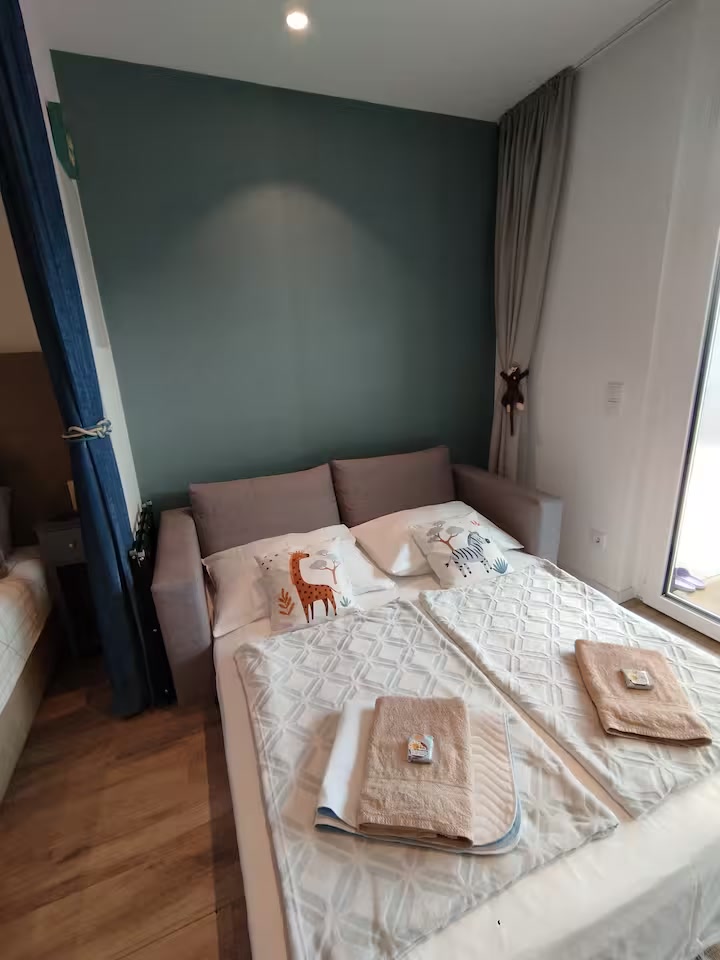 Sofa bed made up with towels and cushions for little guests